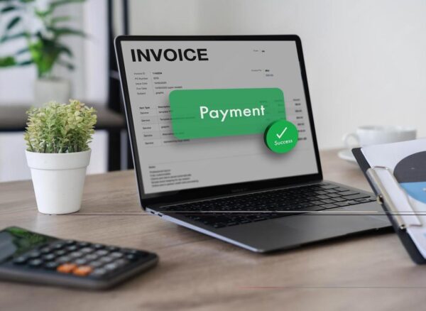 Business team reviewing digital invoices on a laptop, representing e-Invoicing in the UAE