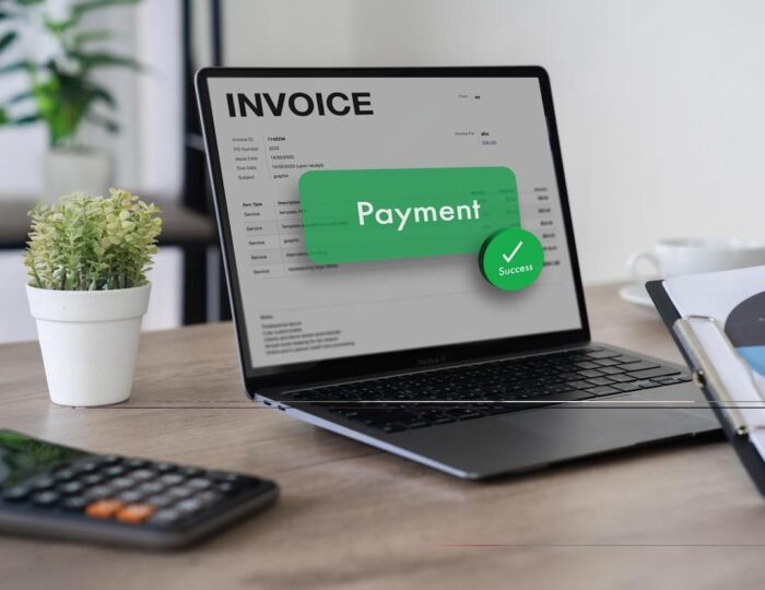 Business team reviewing digital invoices on a laptop, representing e-Invoicing in the UAE