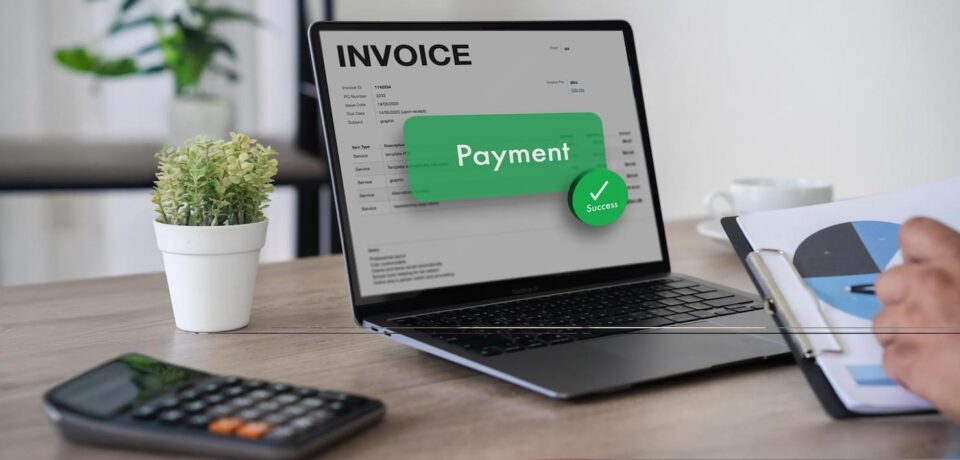 e-Invoicing in UAE – Online Billing & Digital Invoice Compliance with itzoneits Business team reviewing digital invoices on a laptop, representing e-Invoicing in the UAE